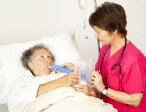 nurse performing breathing exercise with patient