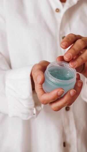 person holding blue plastic container