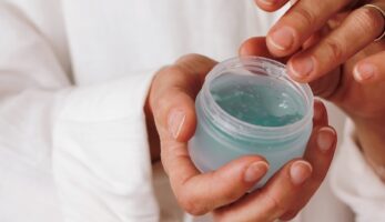 person holding blue plastic container