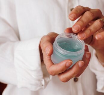 person holding blue plastic container